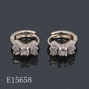 E15658 - 18K Gold Plated Cubic Zirconia Bow Huggie Hoop Earrings for Women | Sparkly Baguette CZ Ribbon Earrings