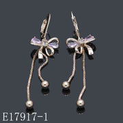 E17917-1 - 18K Gold Plated Bow Dangle Earrings with Lavender Cubic Zirconia & Hanging Chain Tassels
