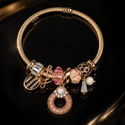 HB00010 - Gold Plated Charm Bracelet with Pink Donut Pendant, Crystal Accents & Pearl Details – 100% Brass