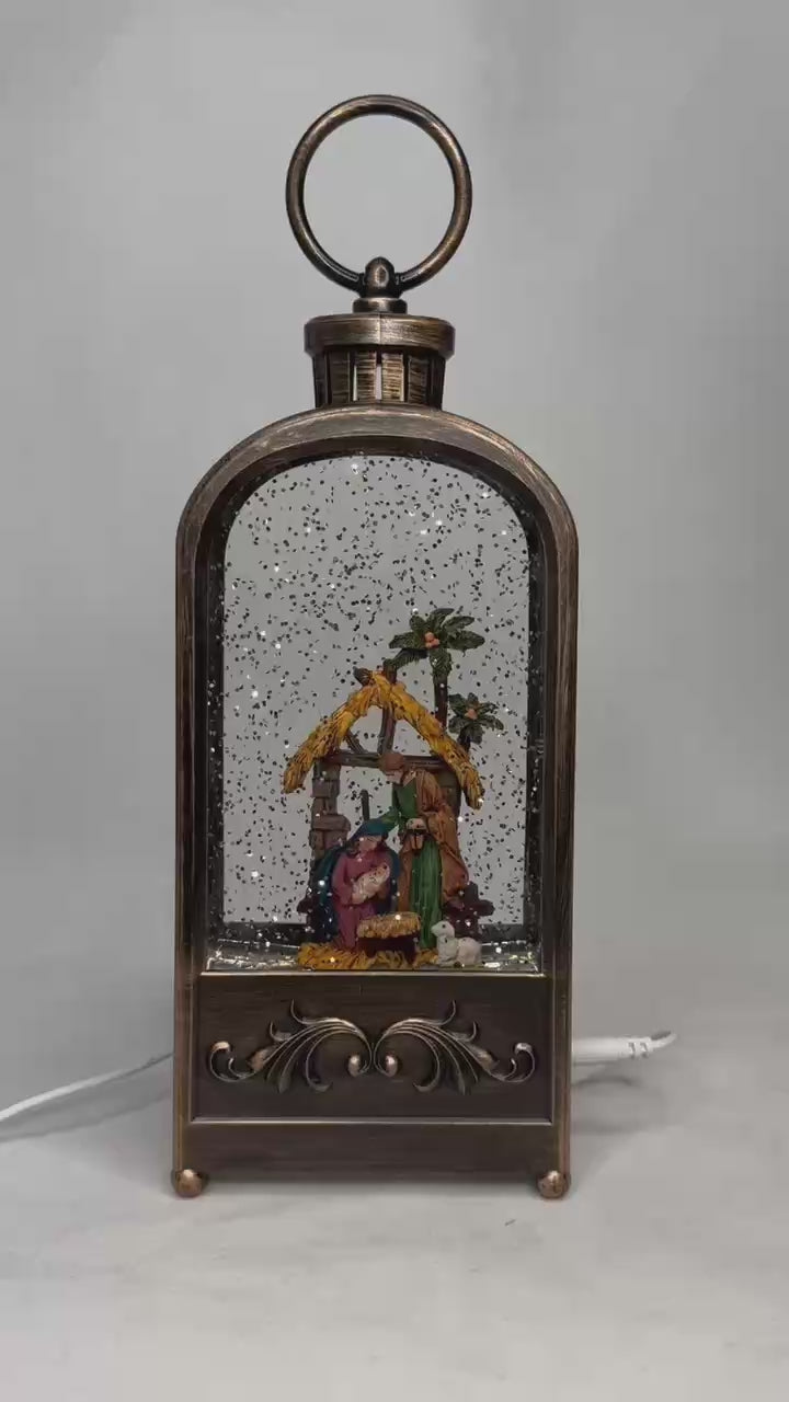 Load video: 2pc/Box Bronze Lighted Water Lanterns with Nativity Scene | Hanging Snow Globe Christmas Decor